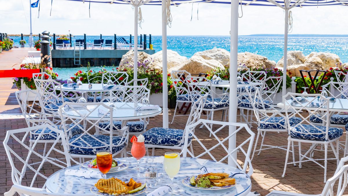 Tables and chairs set up facing the water