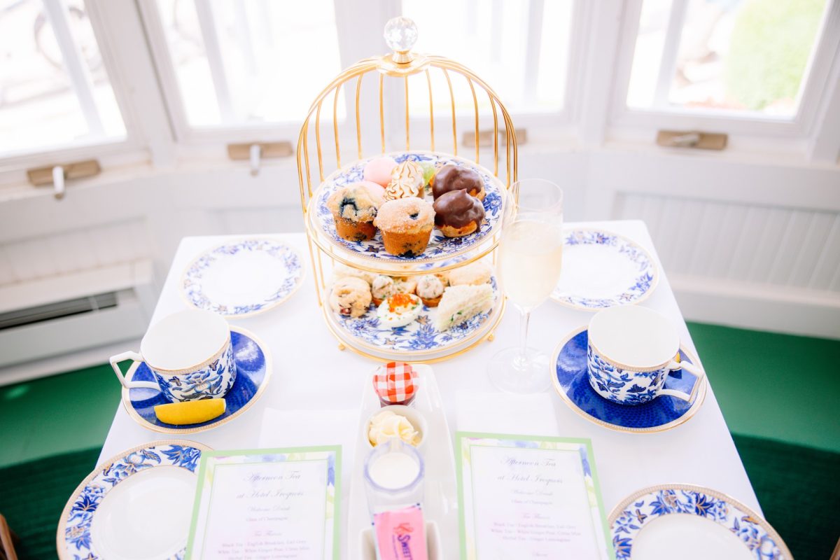 Table set with tea service, plates of food and drinks
